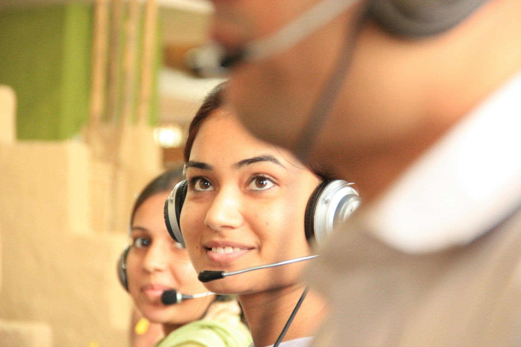Two contact center agents wearing headsets