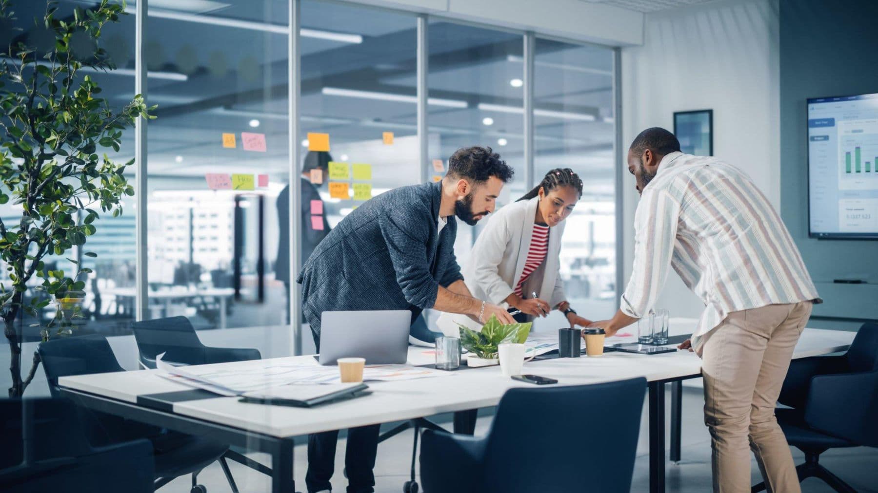 Colleagues planning together around a large office table